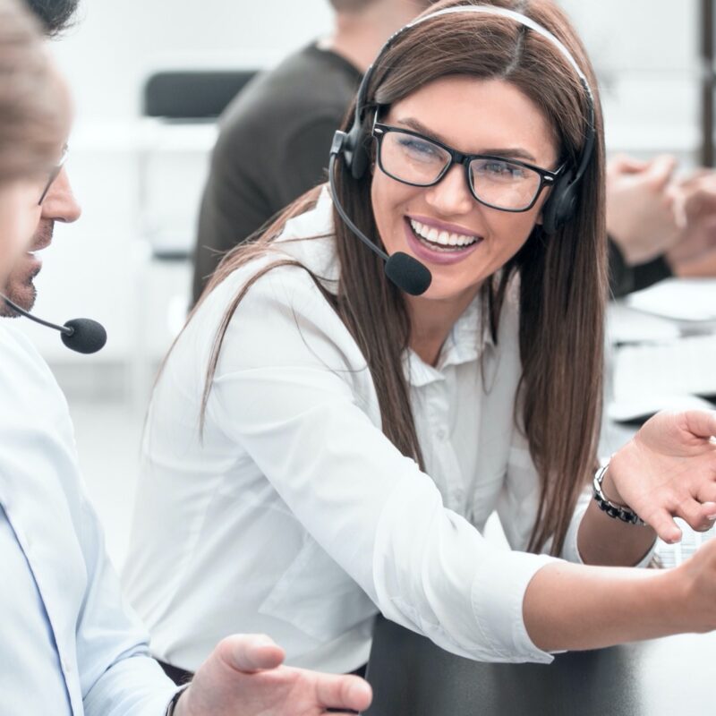 close up.smiling staff call centre to discuss business issues.people and technology